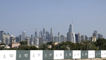 Nhiều tòa tháp ở quận Dubai Marina phía xa, sau các tấm quảng cáo một dự án bất động sản mới ở Dubai, UAE, ngày 1/2/2023. Ảnh: AP 